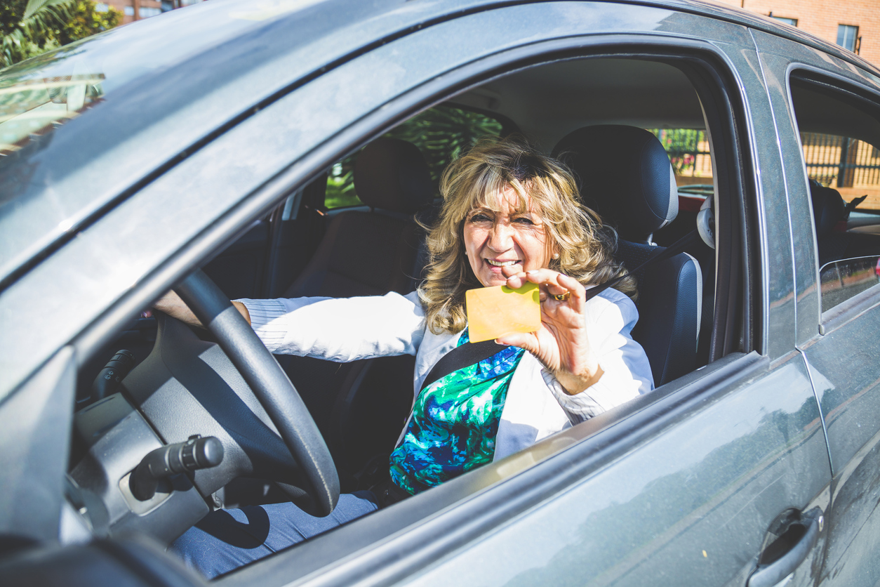 Beauty senior woman driving a car