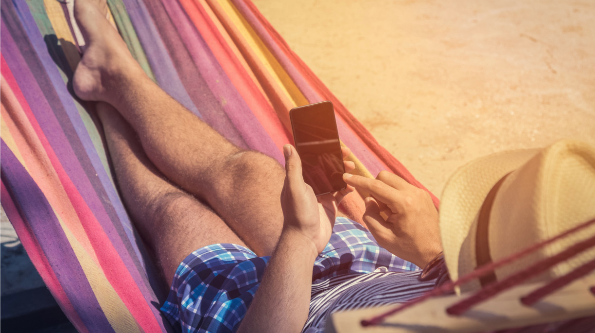 man-using-smartphone-in-hammock-picture-id680694940