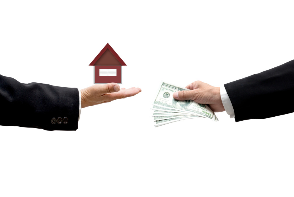 hands-with-money-and-house-as-business-abstract-picture-id480963833