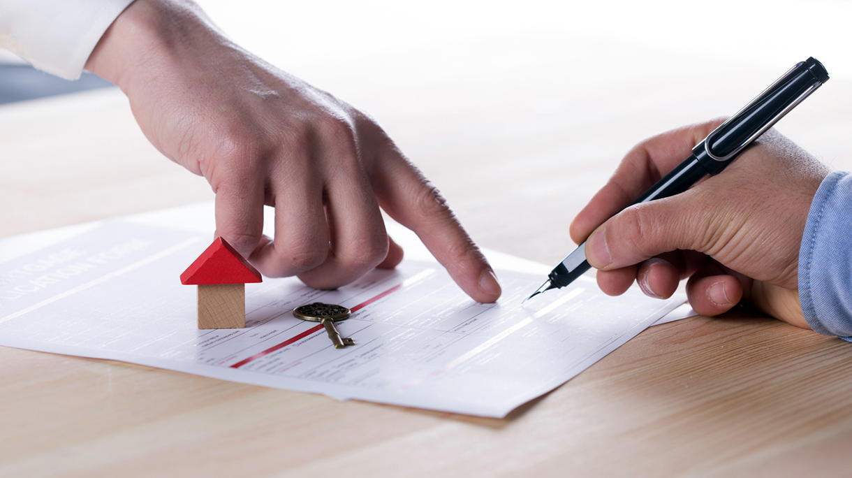 New homeowner signing contract of house sale or mortgage papers
