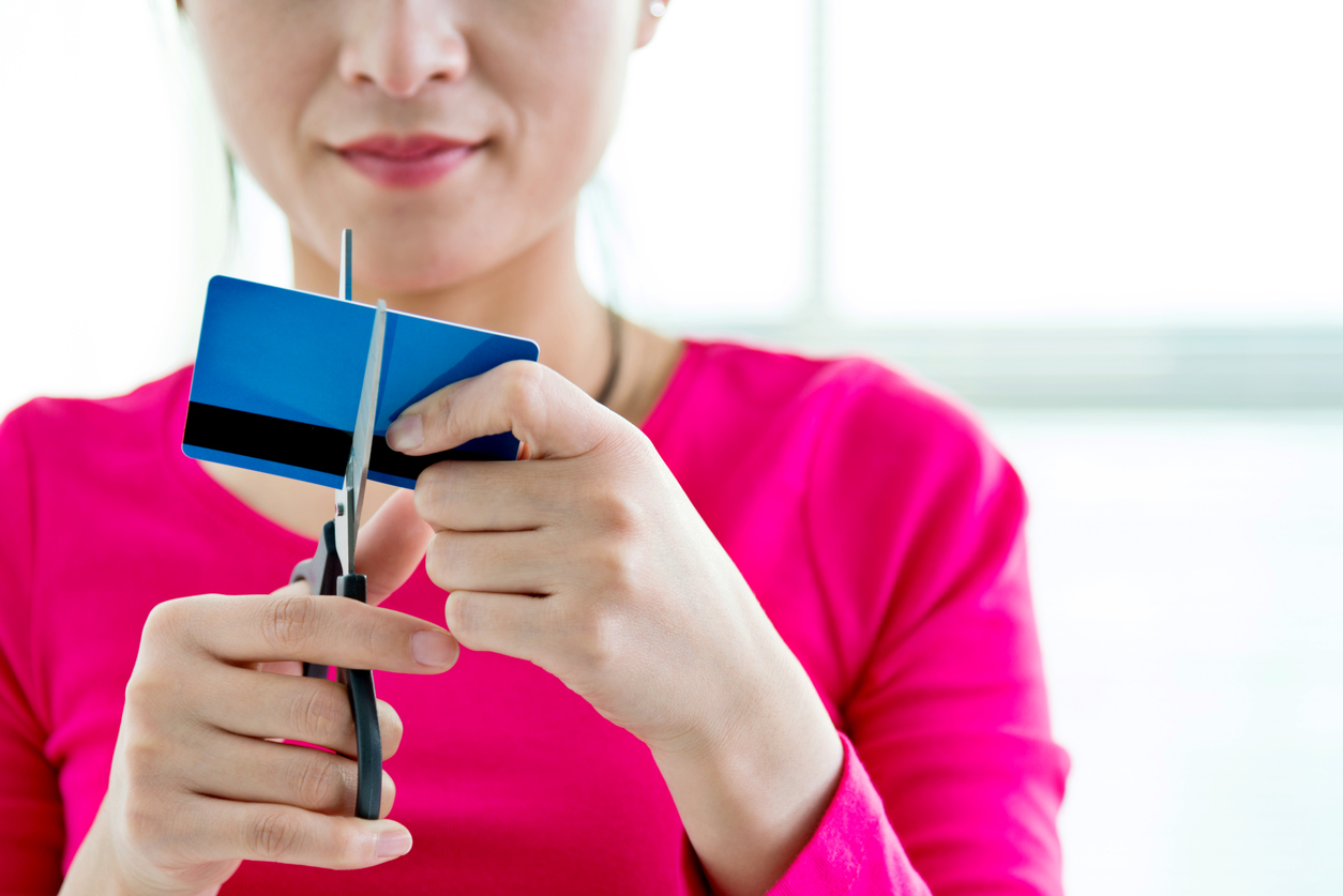 Woman cutting a credit card