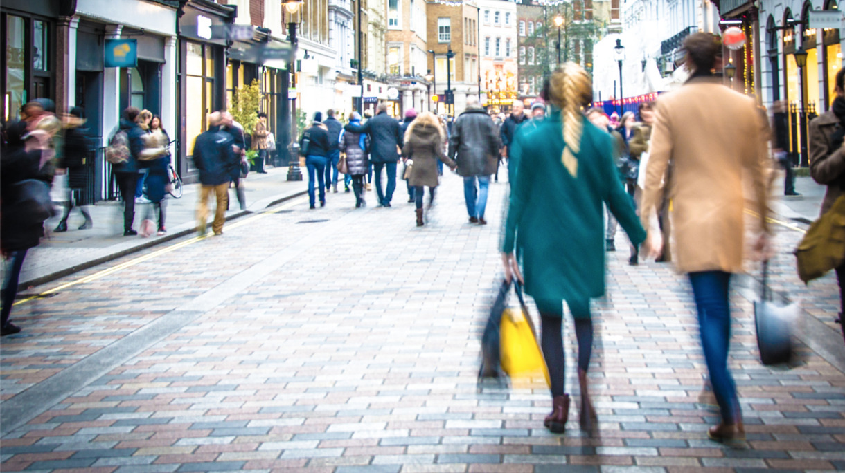 shoppers-walking-down-the-high-street-holding-hands-and-carrying-picture-id838851288