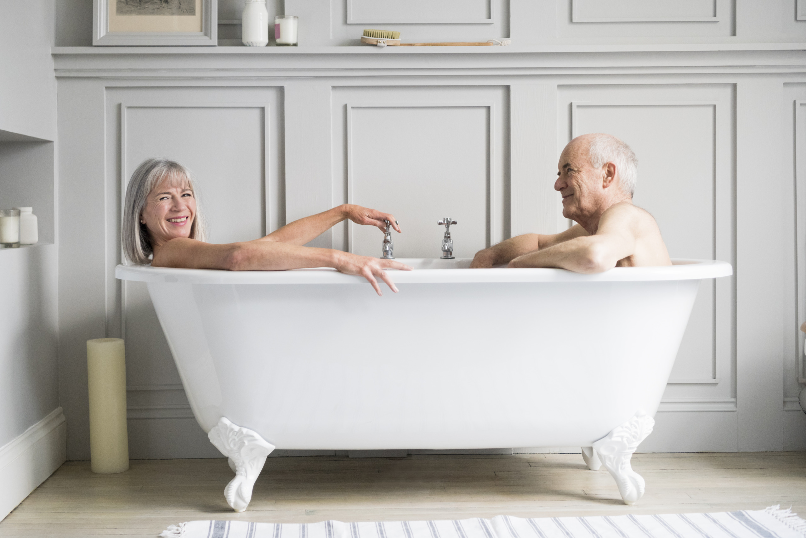 Senior couple in bath together smiling
