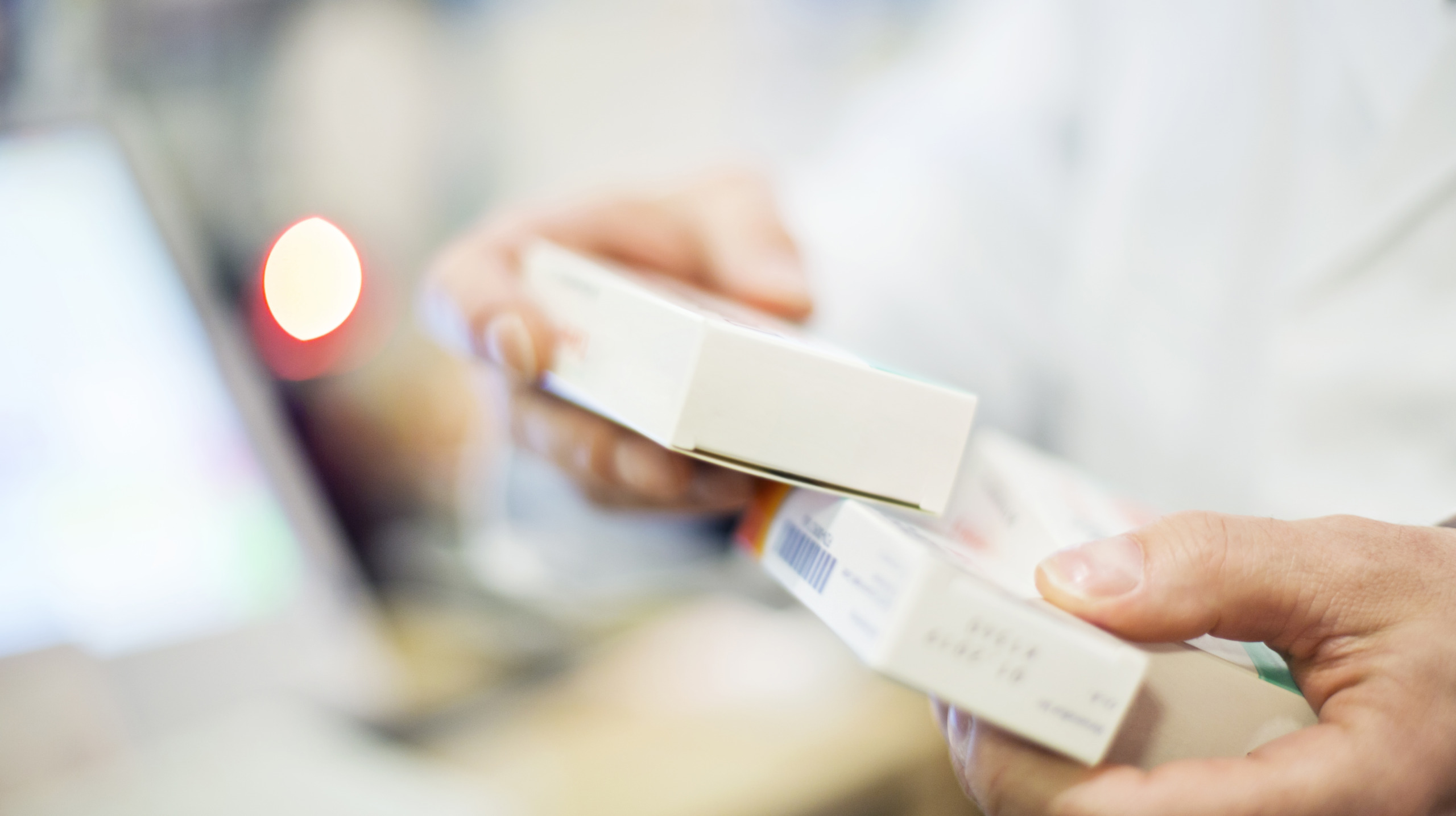 Cropped image of pharmacist holding medicines