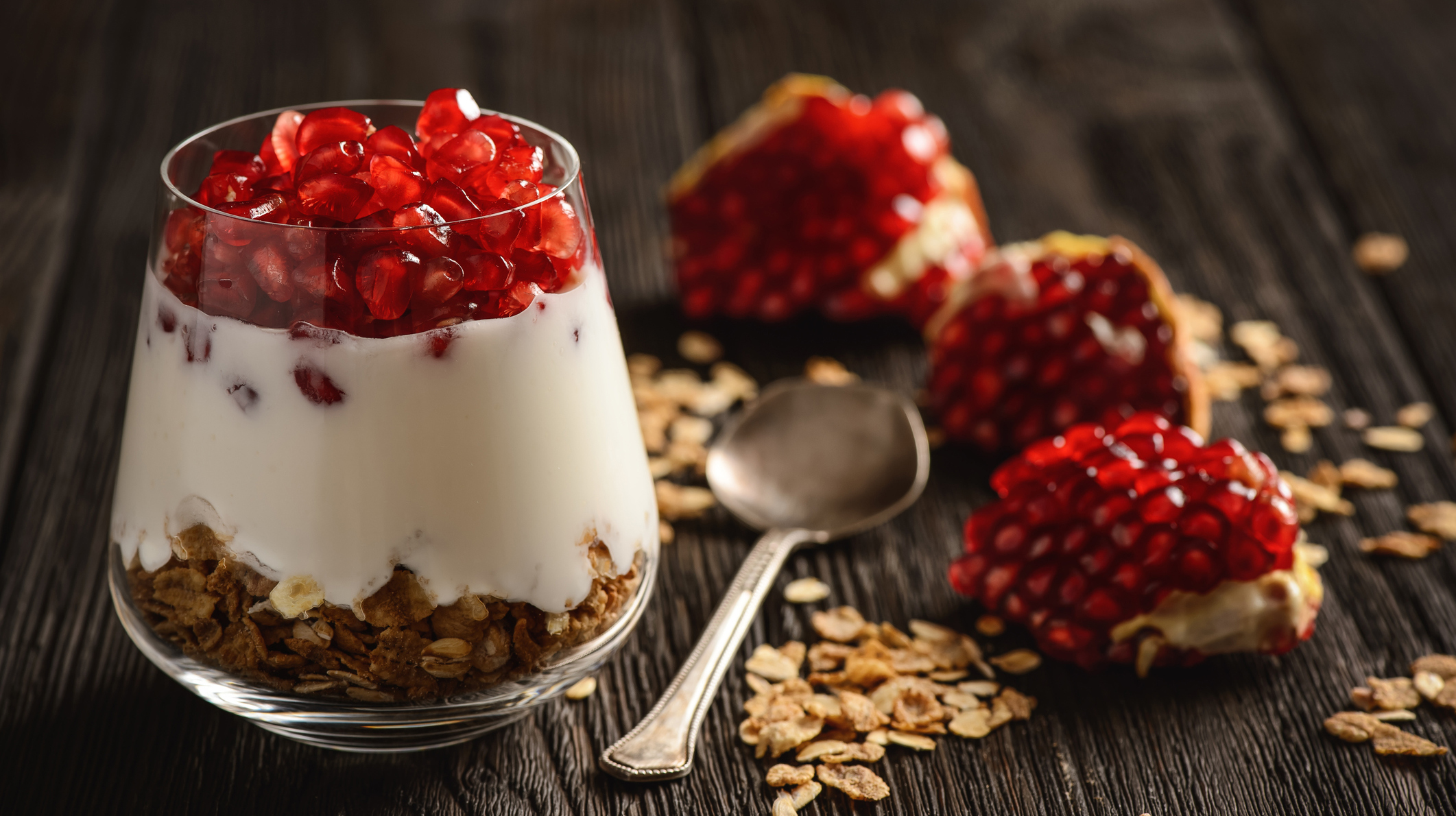 Healthy yogurt dessert with muesli and pomegranate.
