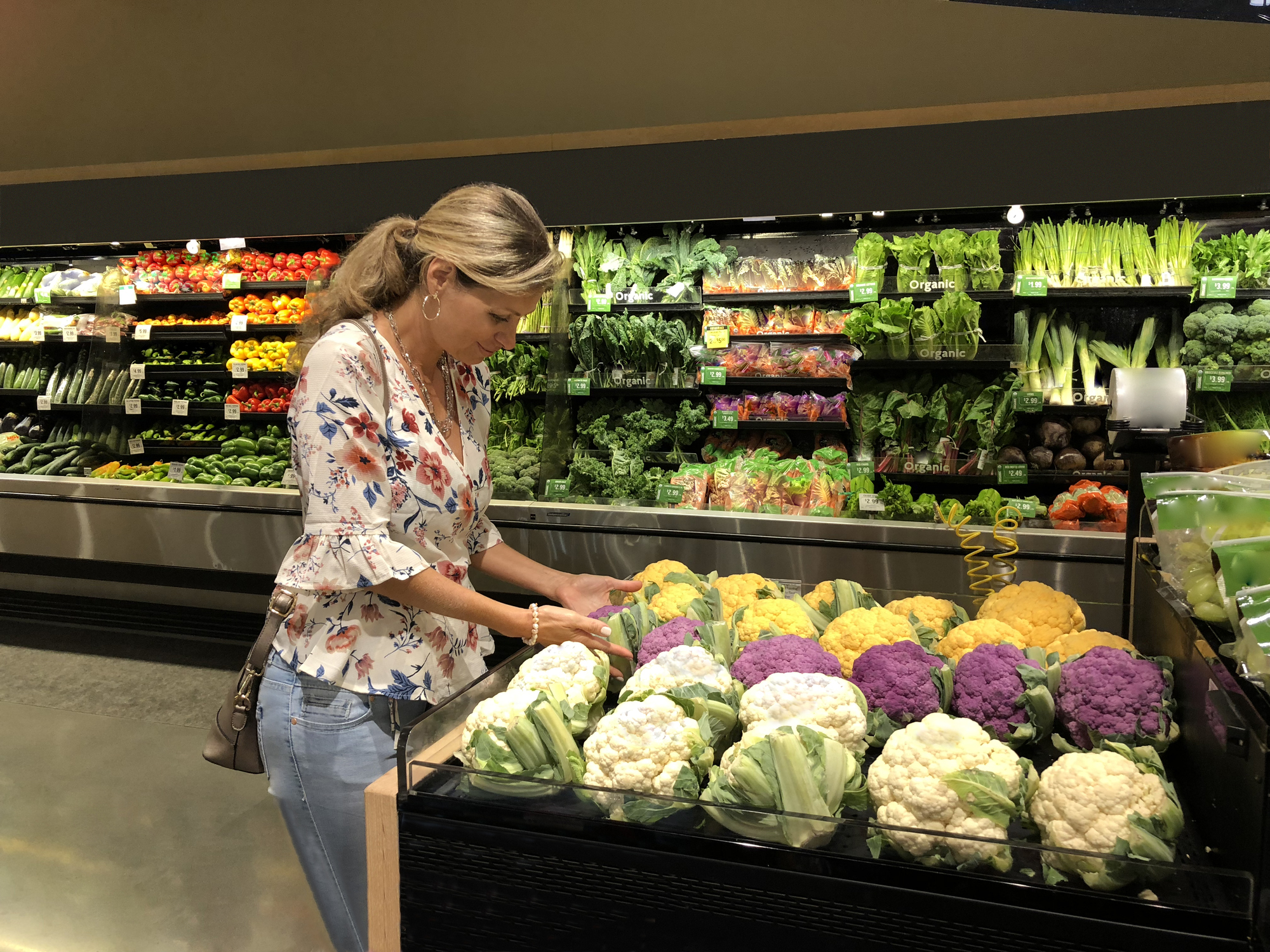 Woman selecting cauliflowers