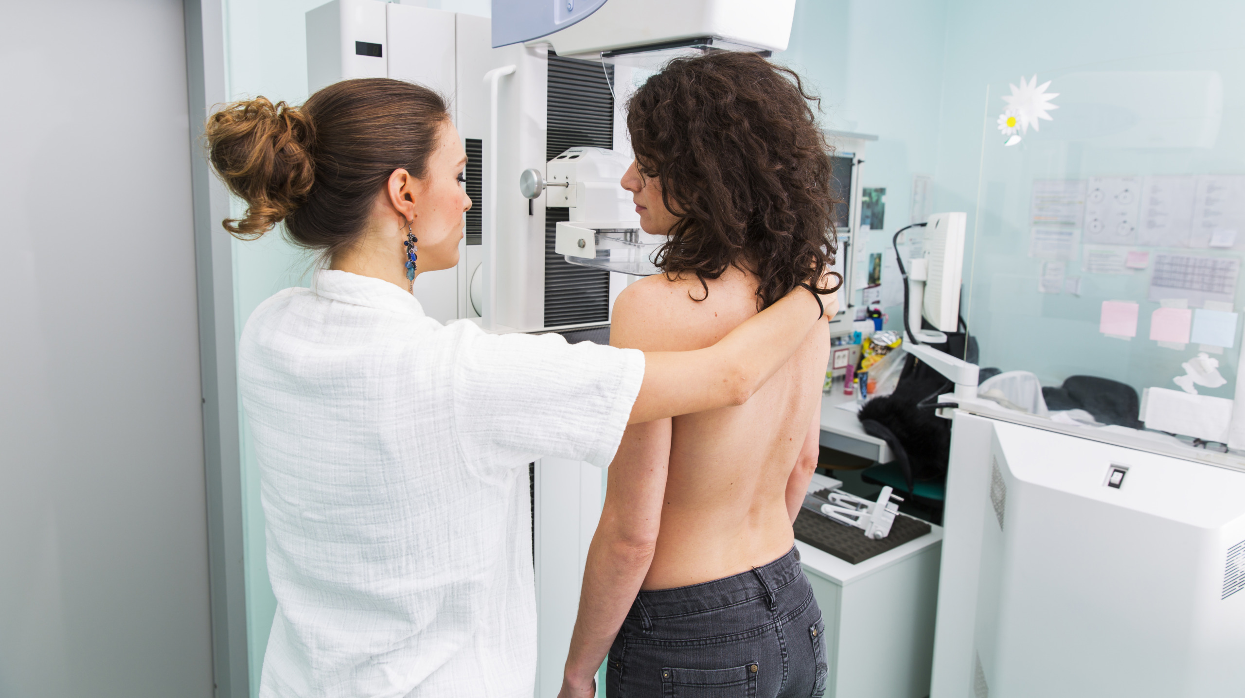 Nurse with young women having a mammography