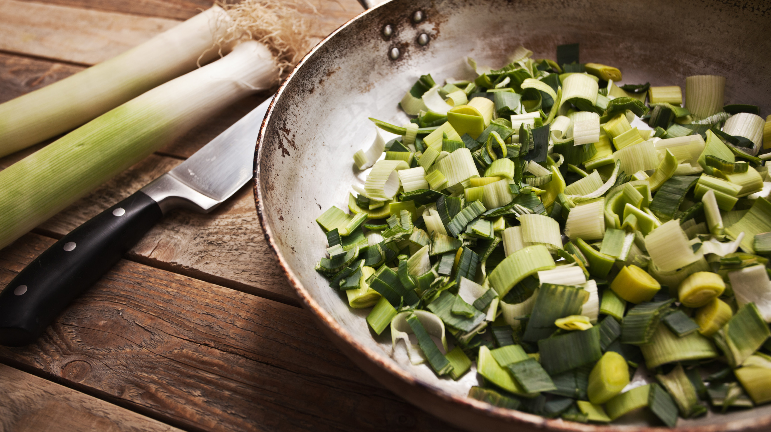 Fresh chopped leek in frying pan