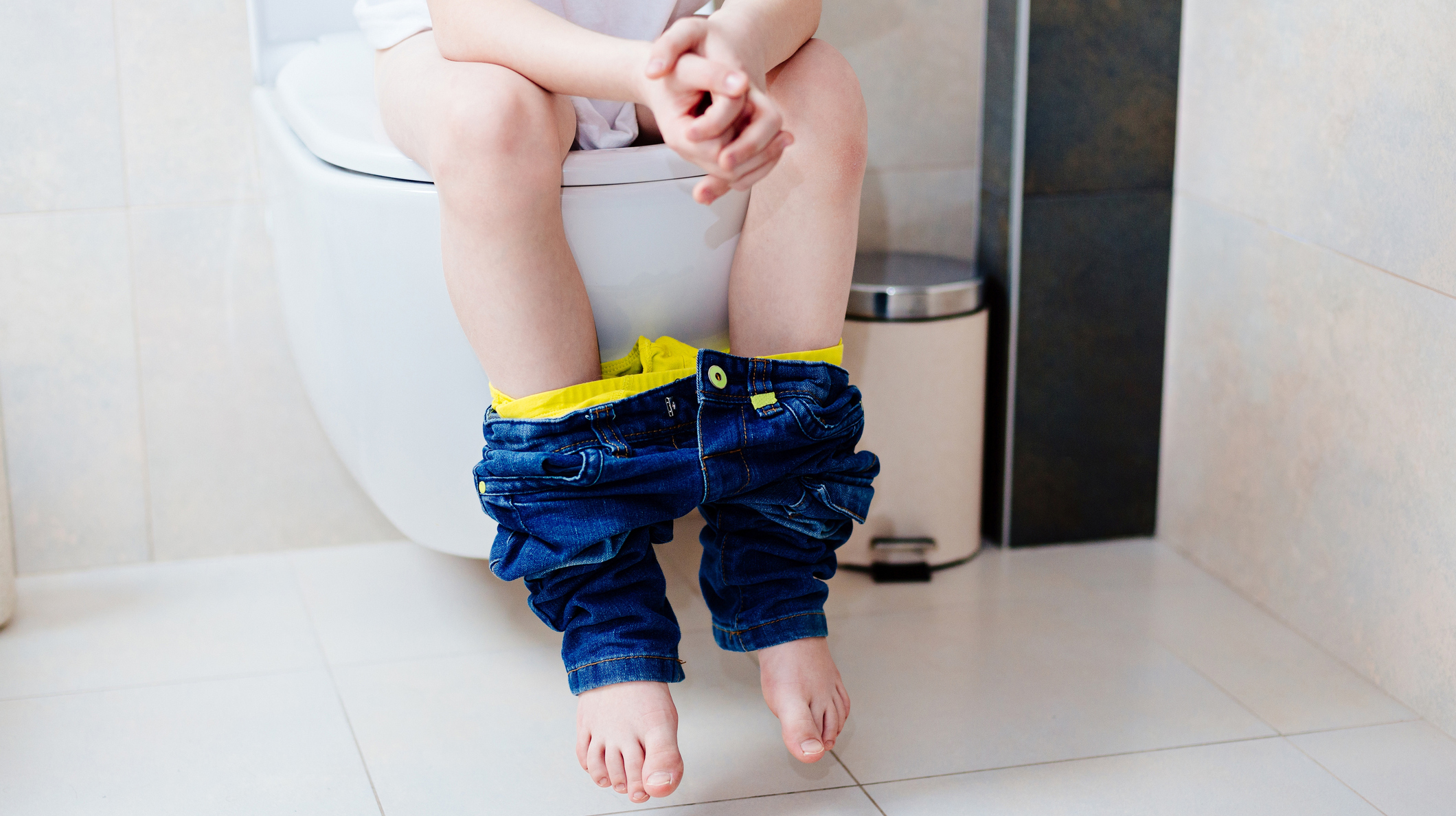Little 7 years old boy on toilet.