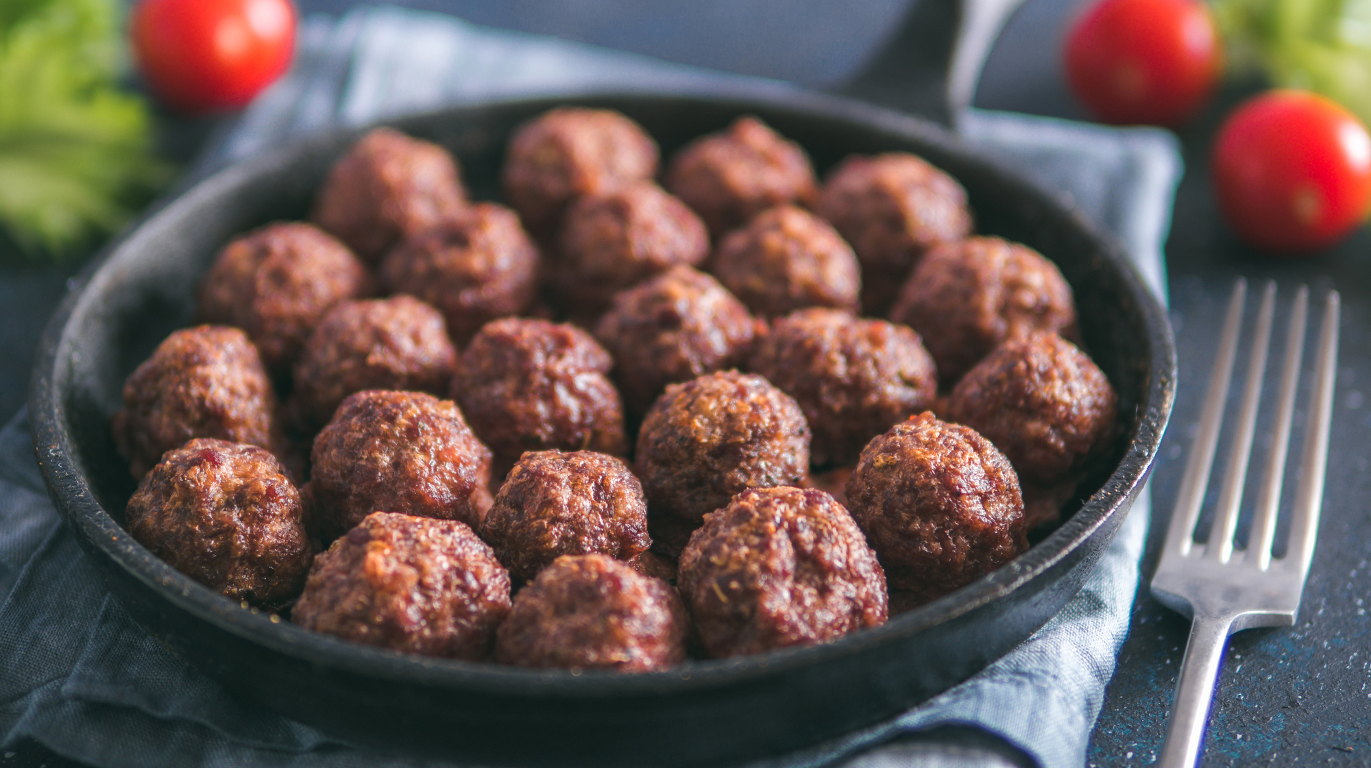 Homemade beef meatballs in cast-iron skillet