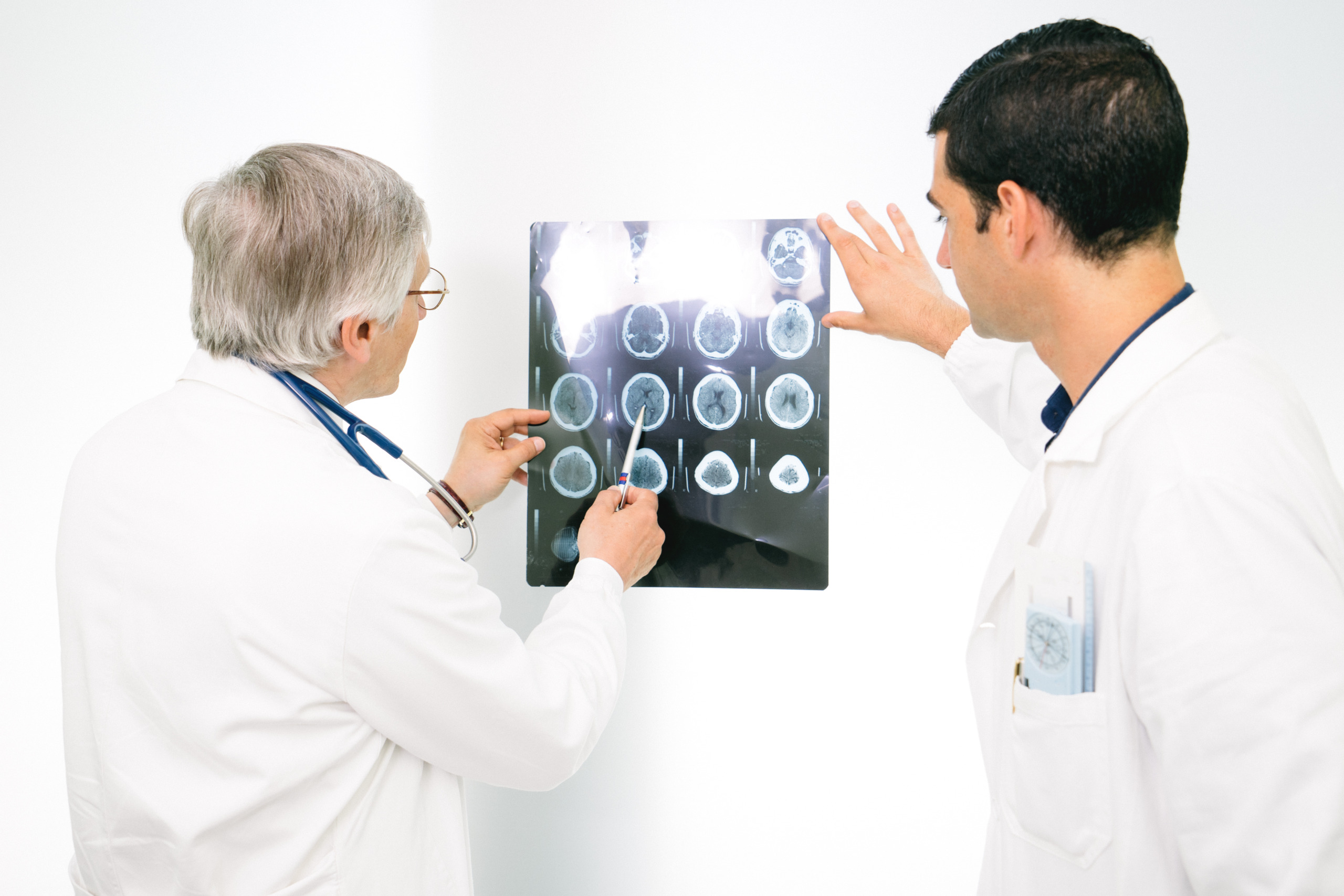 Doctors Consult Over An MRI Scan Of The Brain