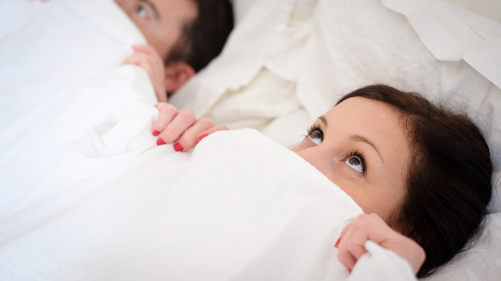 Funny lovers couple lying in the bed
