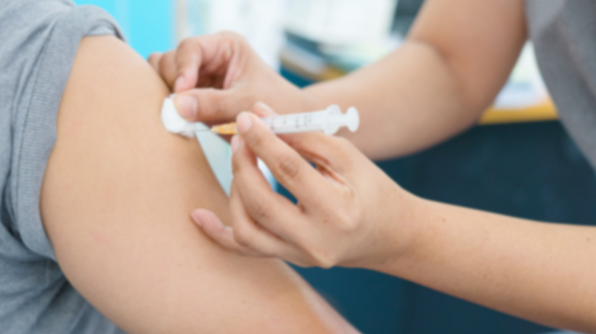 Blurry Background of Nurse are vaccinations to patient. To prevent diseases that are prevalent. closed-up of hand with vaccine shot.