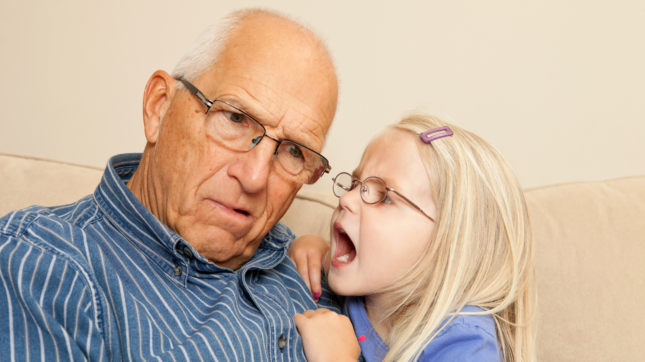 Child Girl Yelling into Grandfather’s Ear