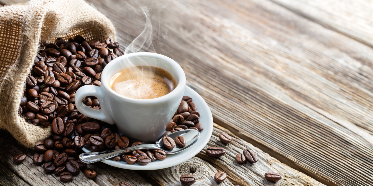 Espresso Coffee Cup With Beans On Vintage Table