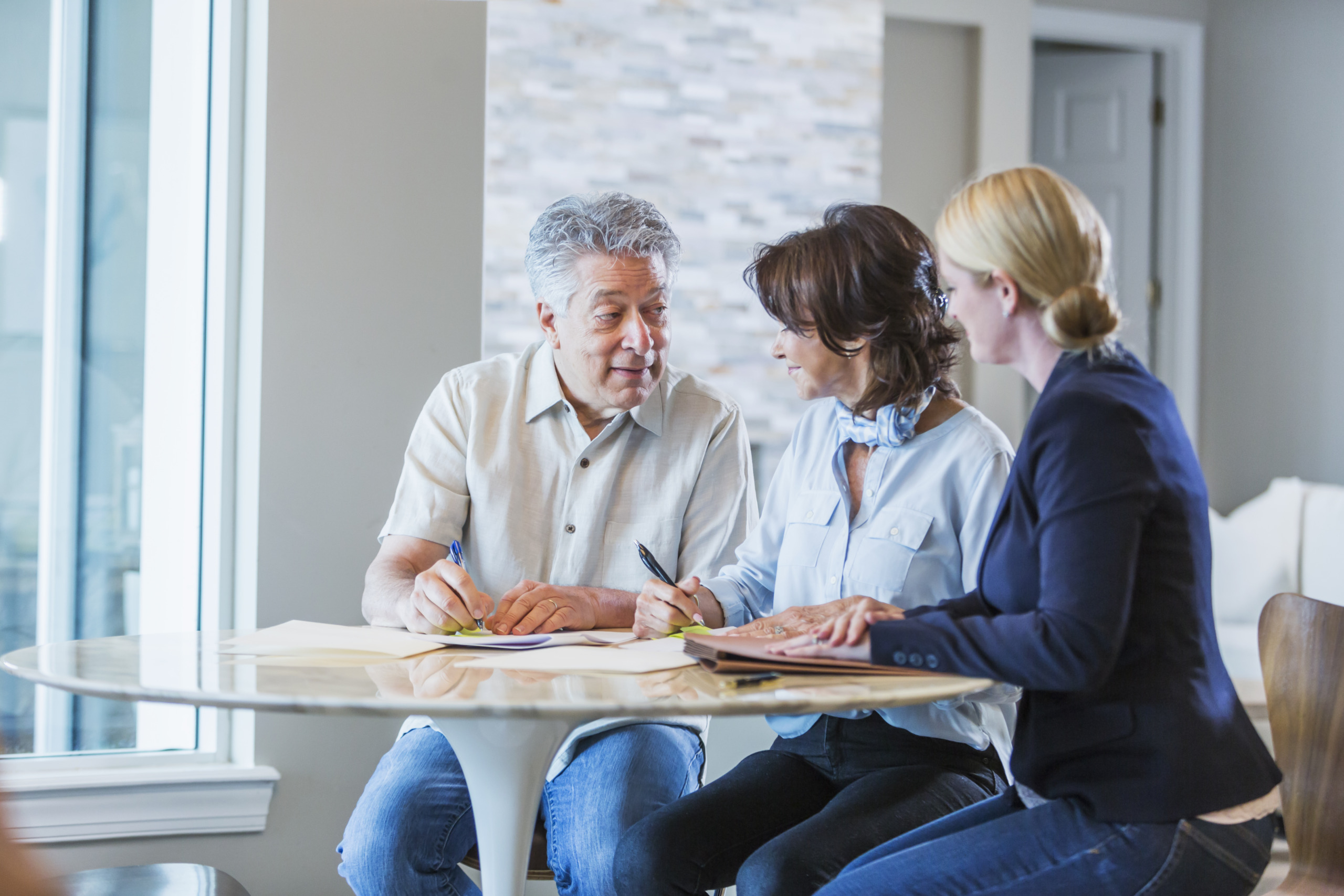 Family with adult daughter working on home finances