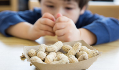 Little boy eating peanuts