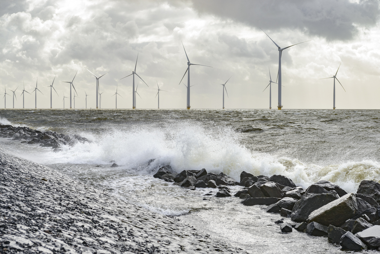 Wind turbines on land and offshore in a storm