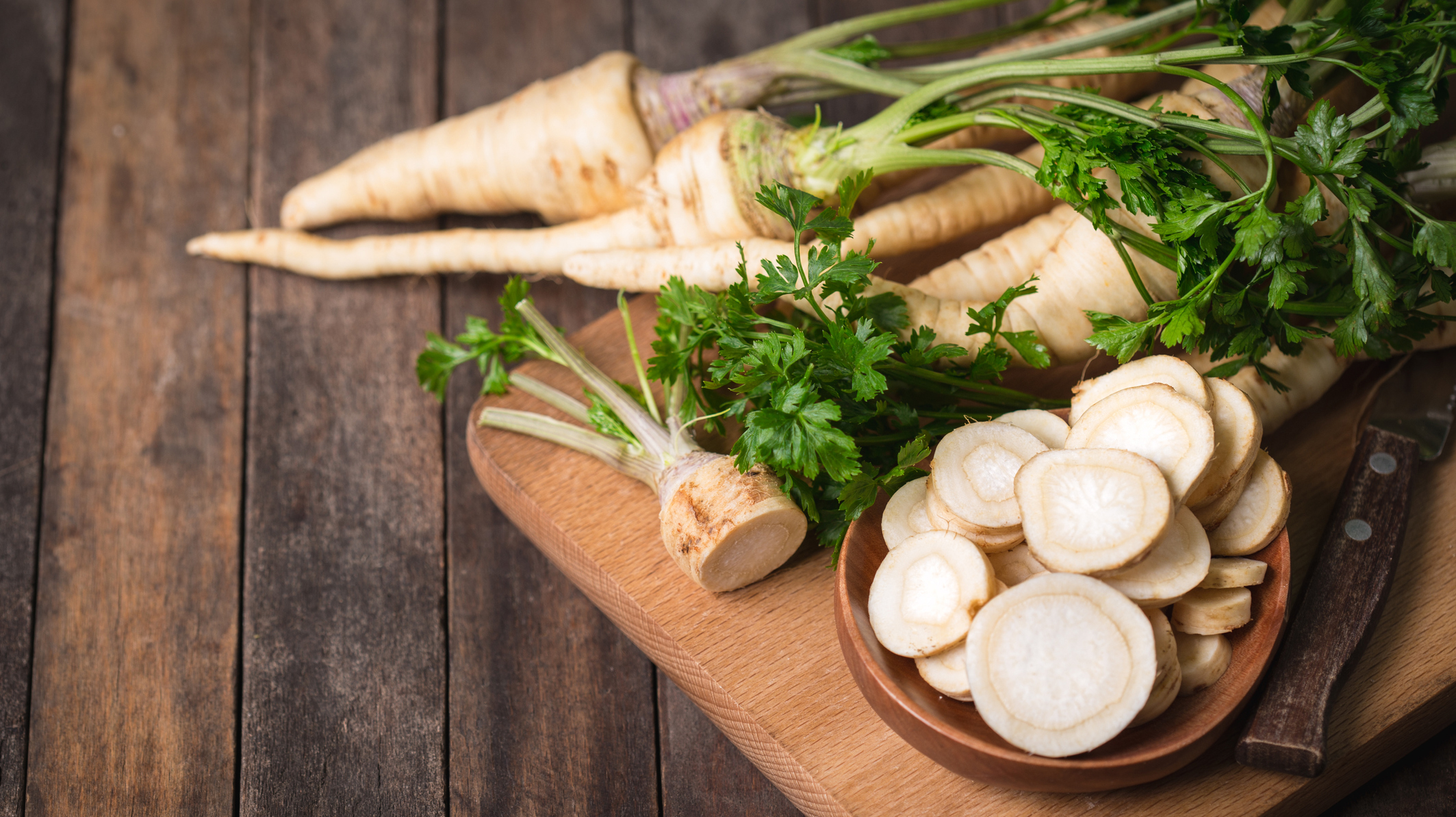 Fresh parsley root on the wooden table