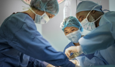 Multi-ethnic doctors operating girl at hospital