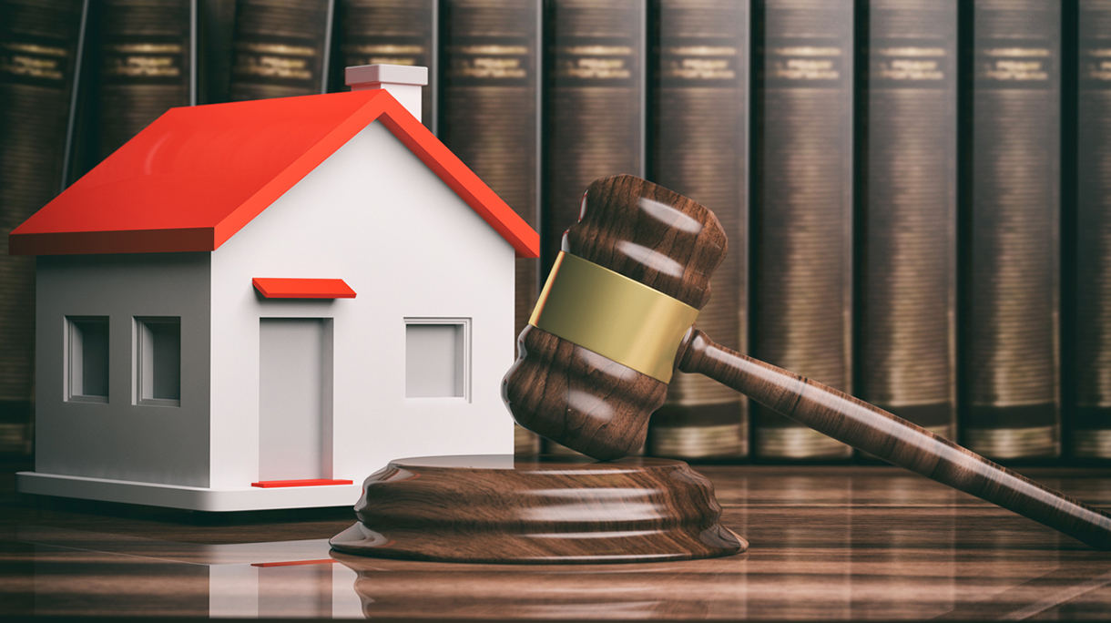 Wooden auction or judge gavel, a small house and books. 3d illustration