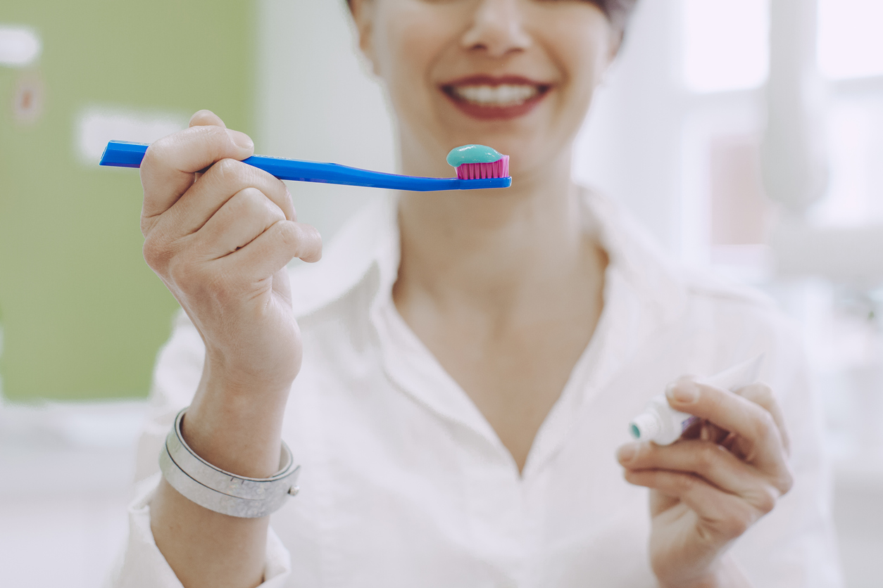 Dentist showing toothpaste and toothbrushes