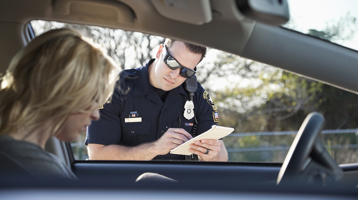 Police officer writing ticket