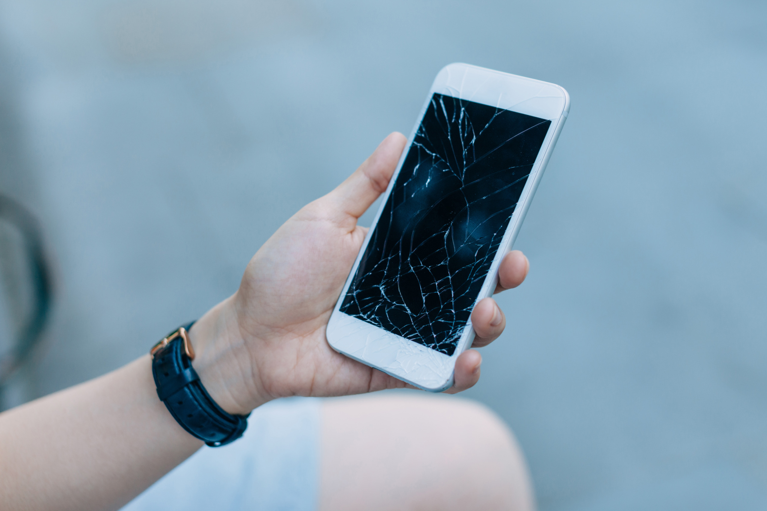 Woman with shattered cell phone