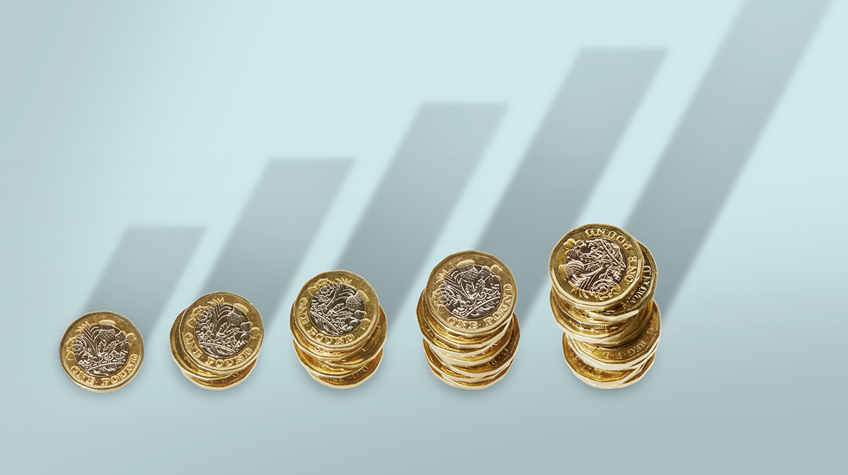 Ascending stacks of pound coins with bar graph growth shadow