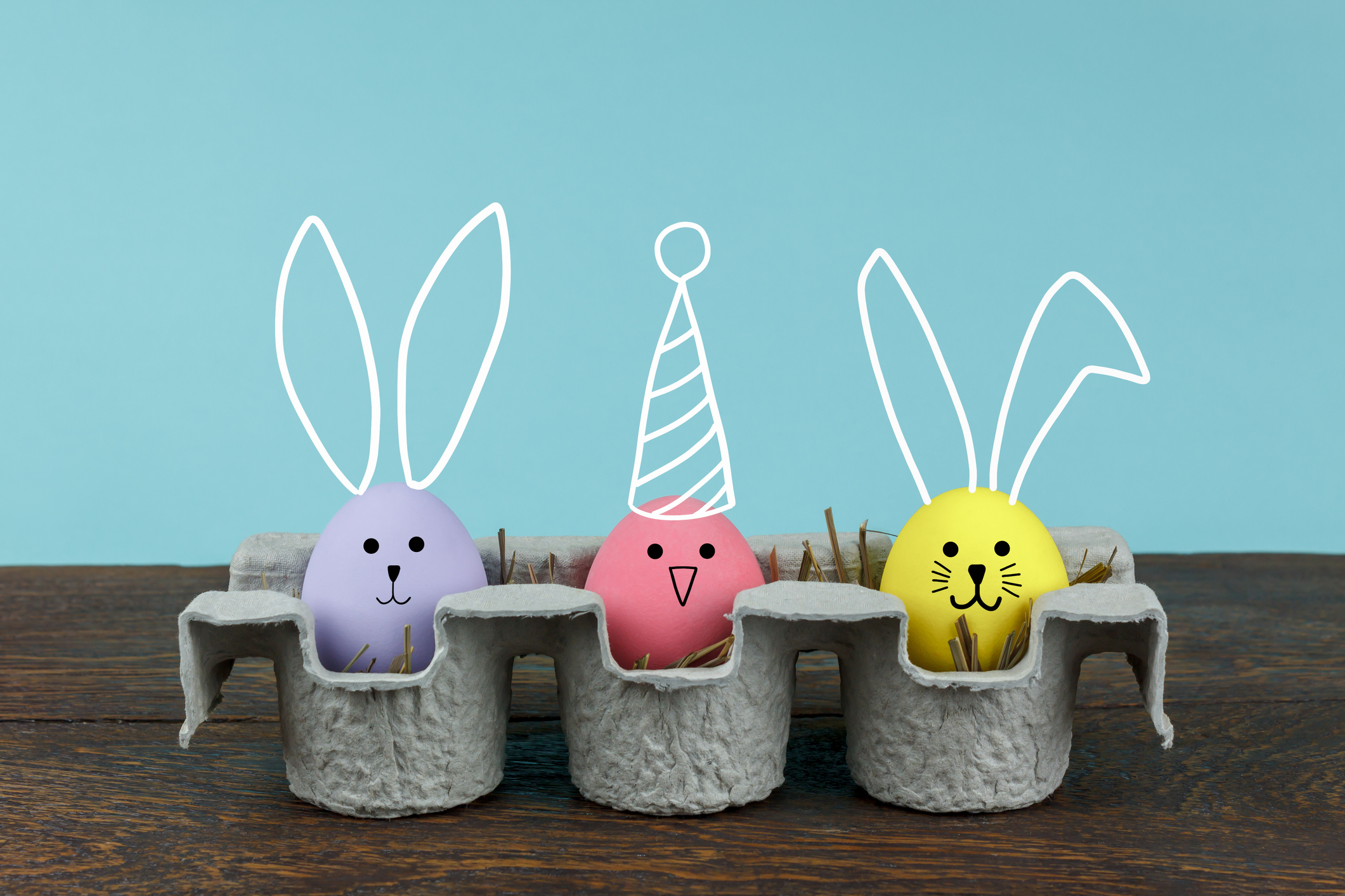 Digital Composite Image Of Colorful Easter Eggs On Table Against Blue Background