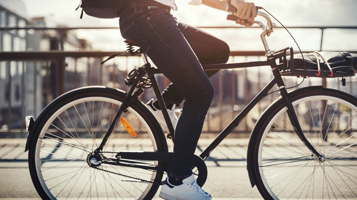 Low section of businessman riding bicycle on bridge