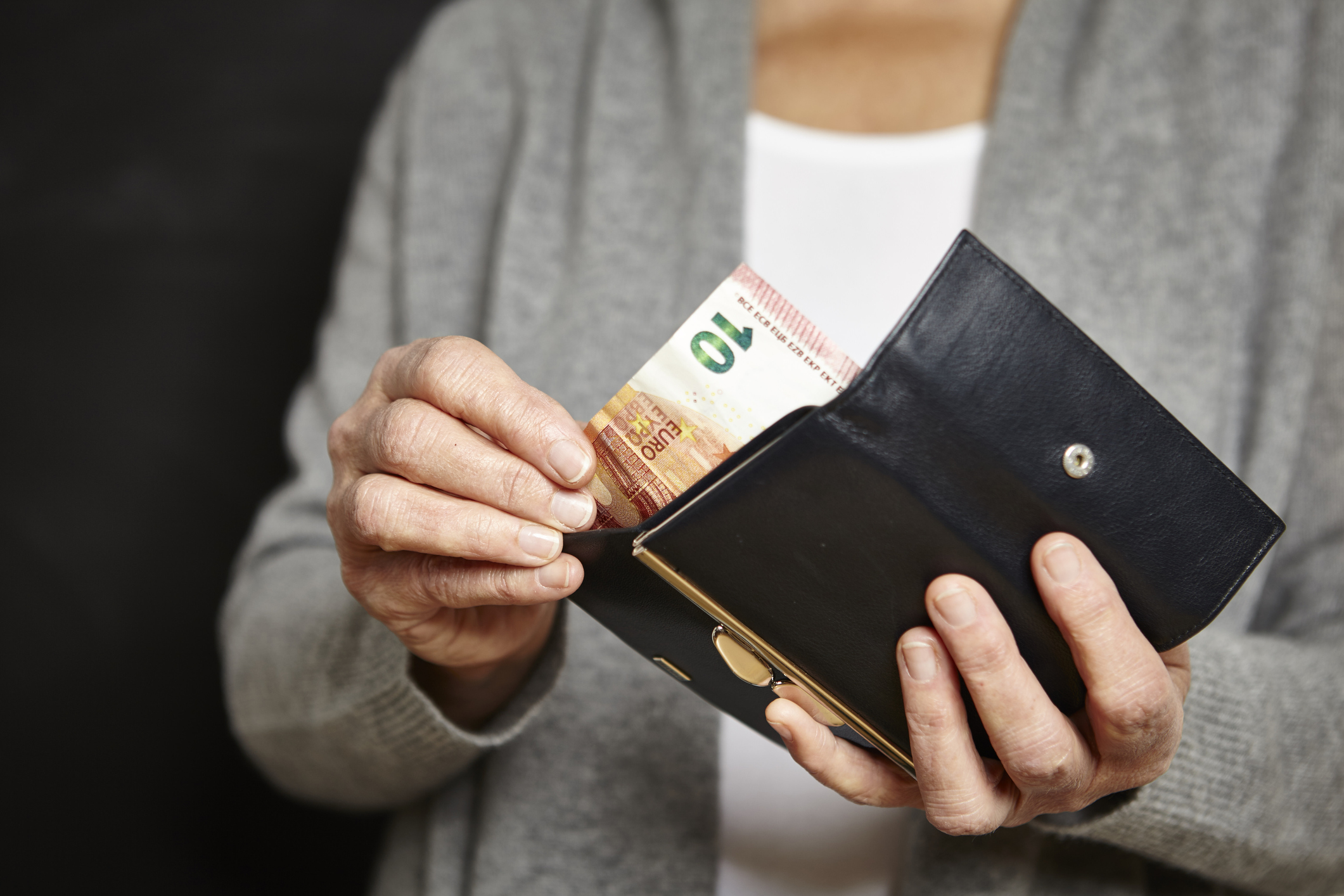 Woman getting money out of her wallet