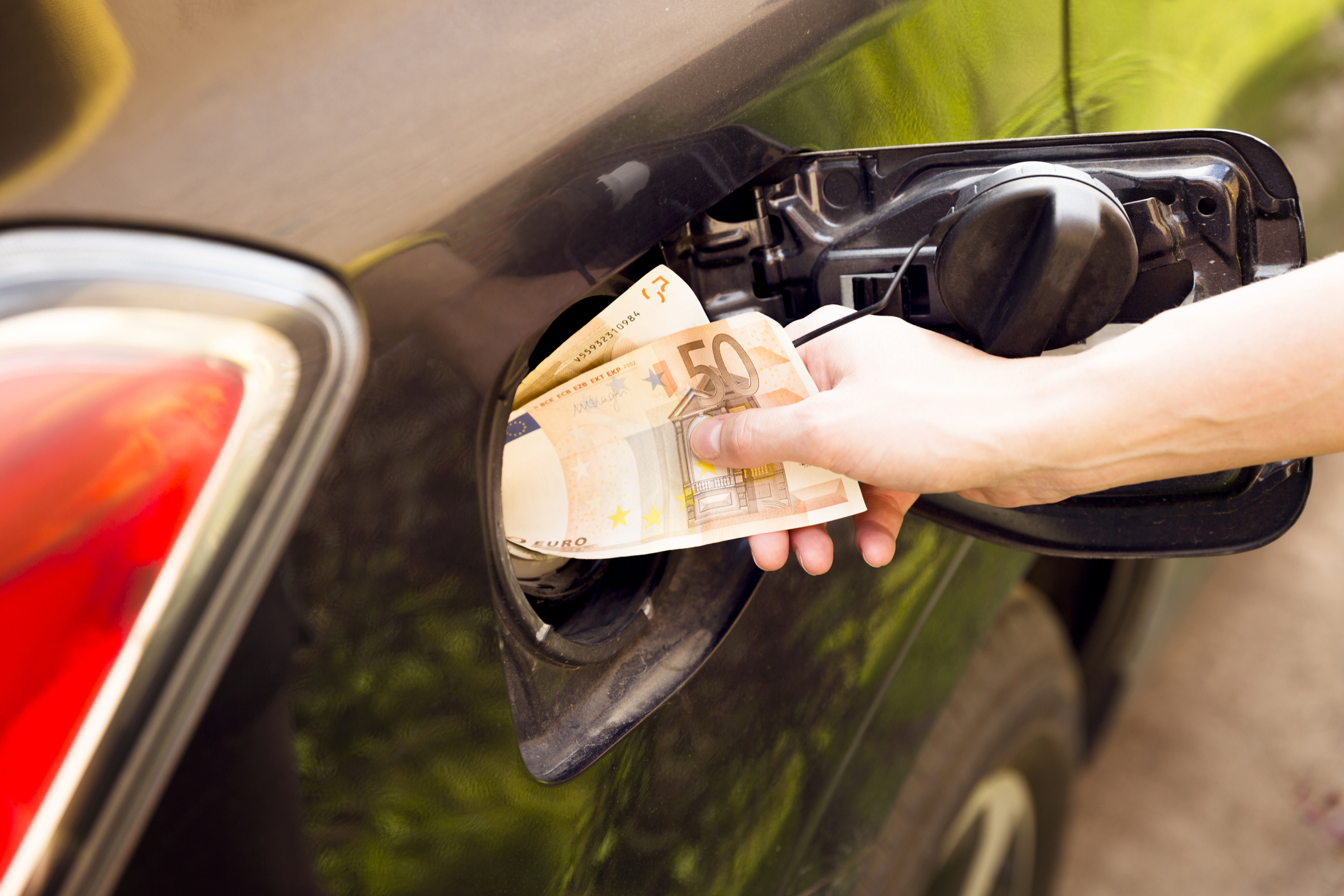 Transportation expenses concept – Euro money in car fuel tank