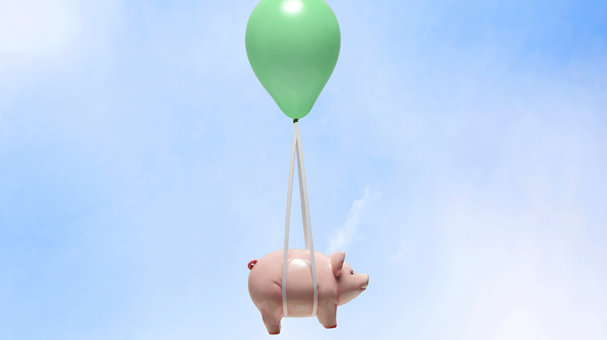 Piggy bank being carried by balloon