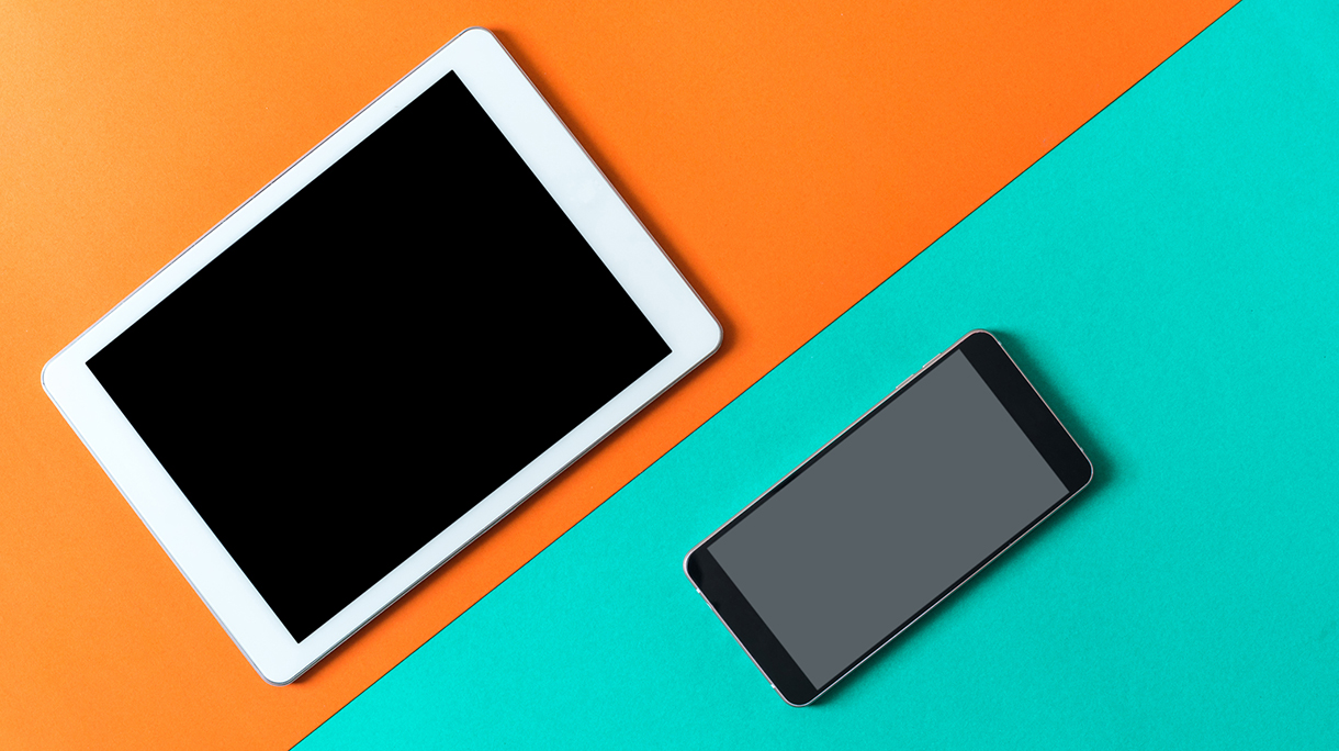 High Angle View Of Smart Phone And Digital Tablet Over Colored Background