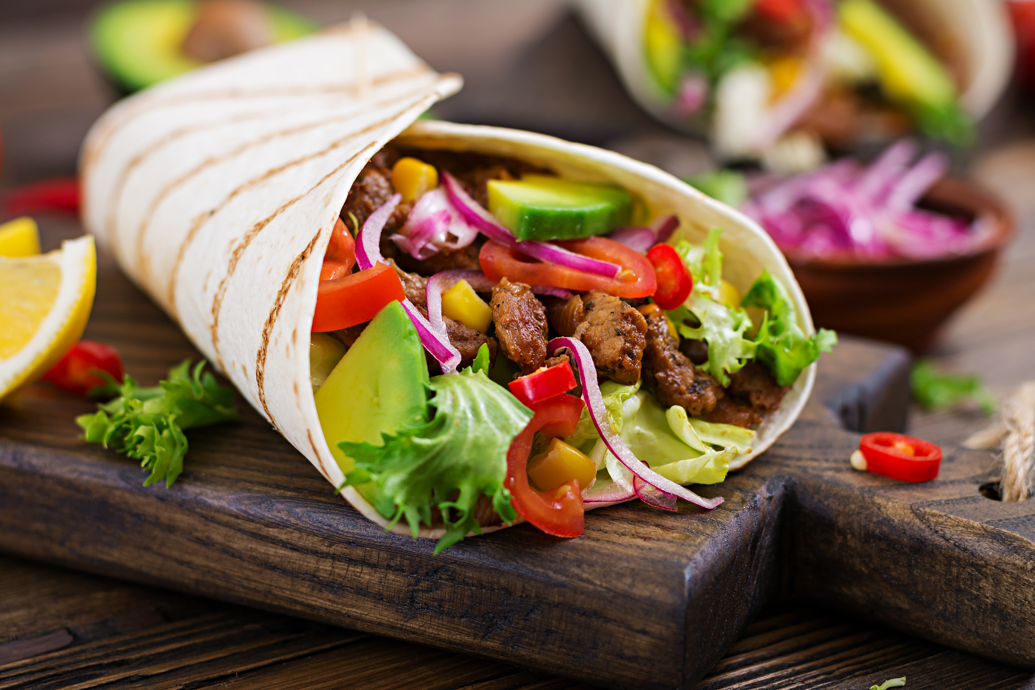 Mexican tacos with beef in tomato sauce and avocado salsa