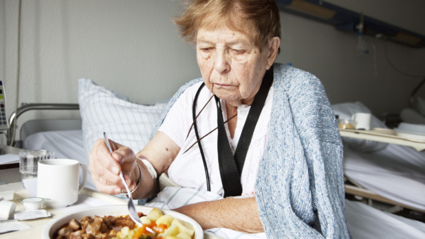 senior woman in hospital eating