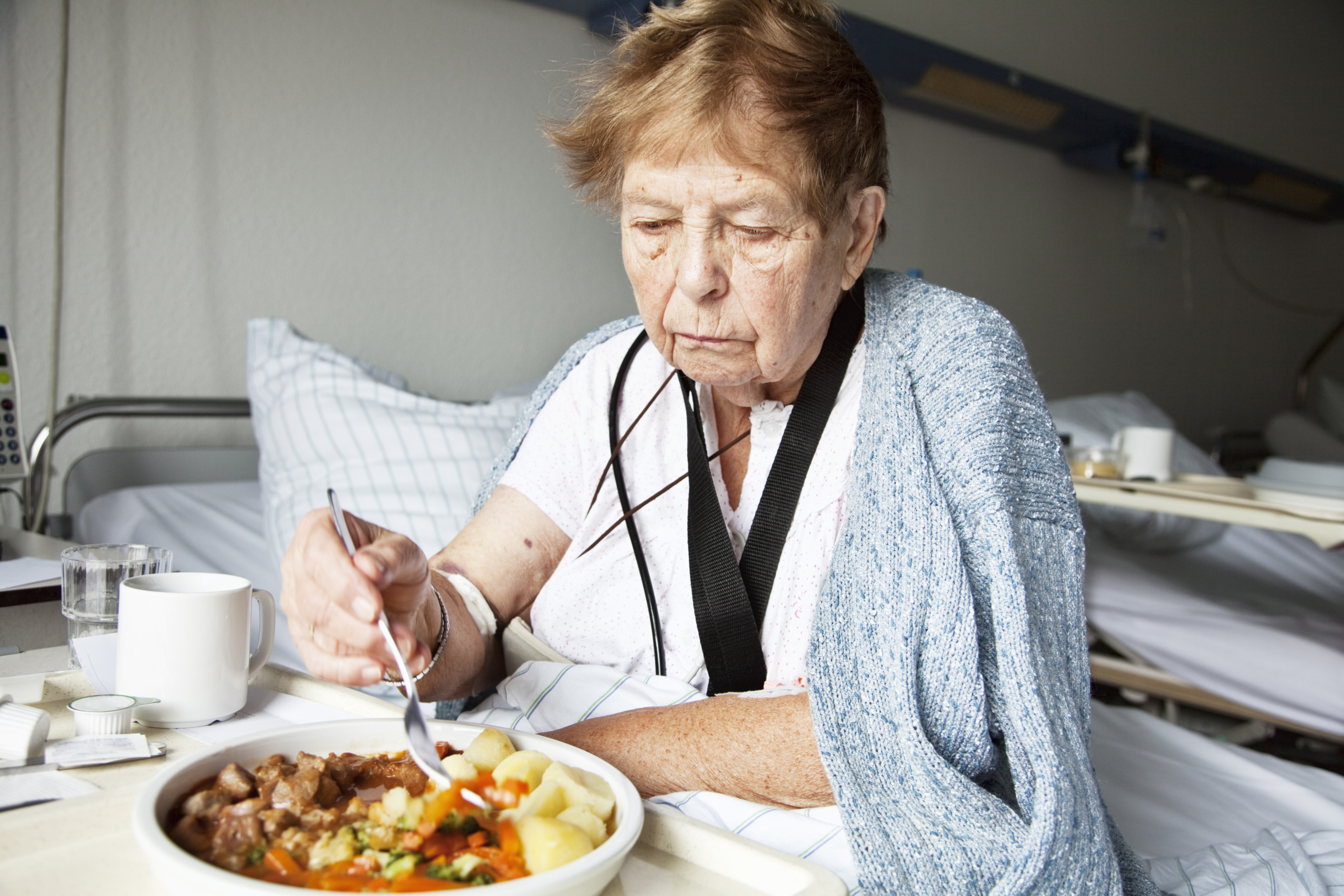 senior woman in hospital eating