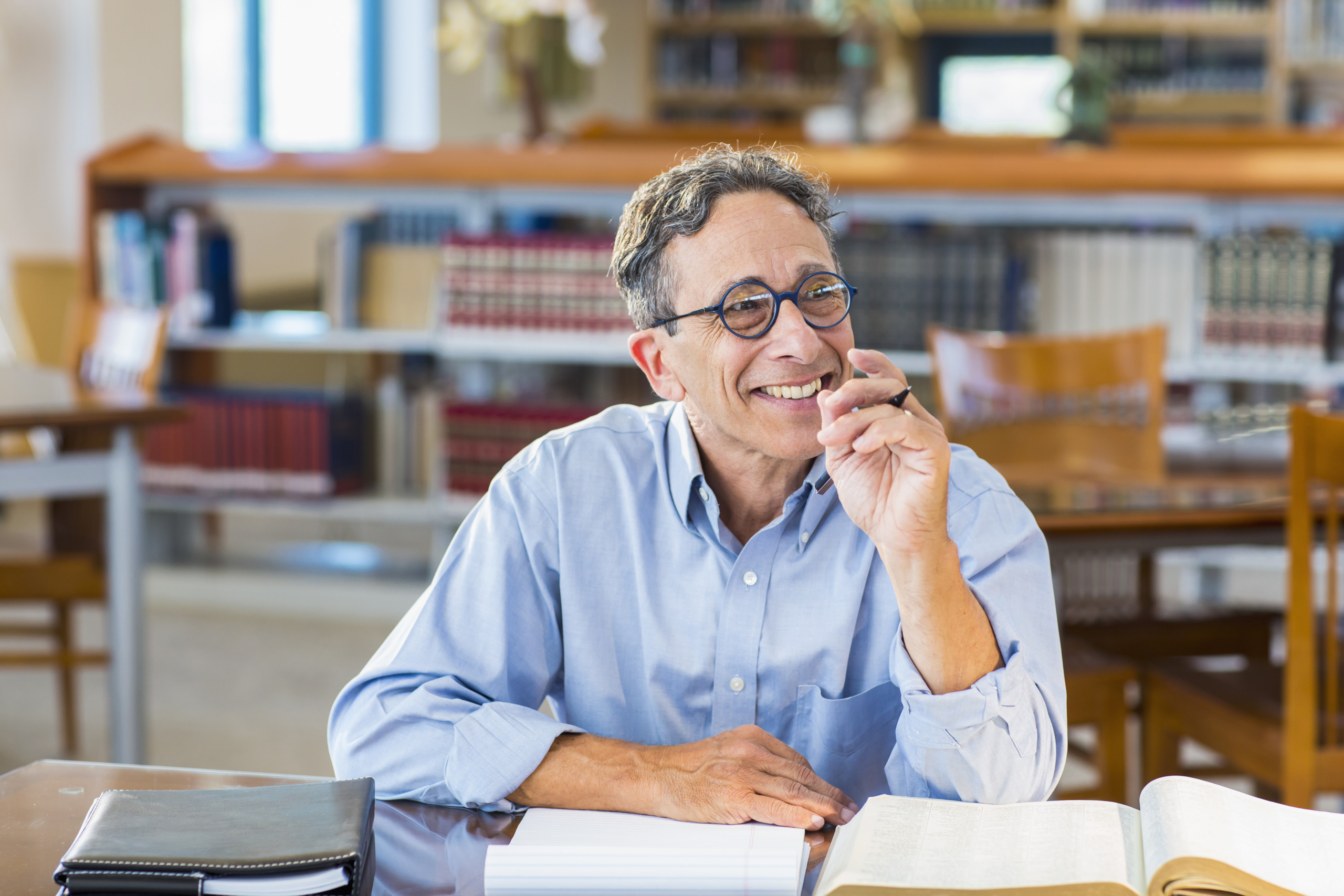 Senior man reading in library