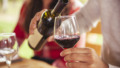 Man pouring red wine into glass