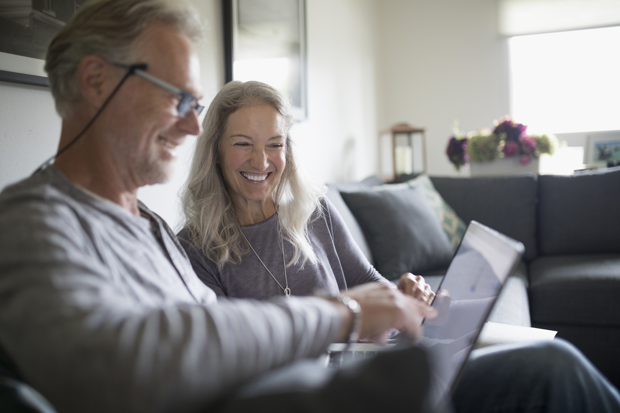 Smiling senior couple using laptop