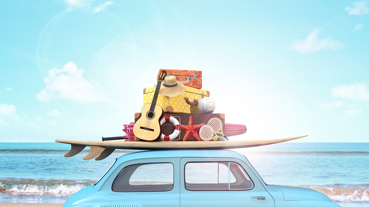 Car with luggage on the roof ready for summer vacation