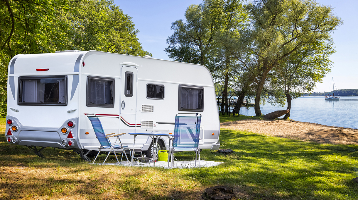 Vacations in Poland – Camper trailer on the shore of bay of the Drawsko lake