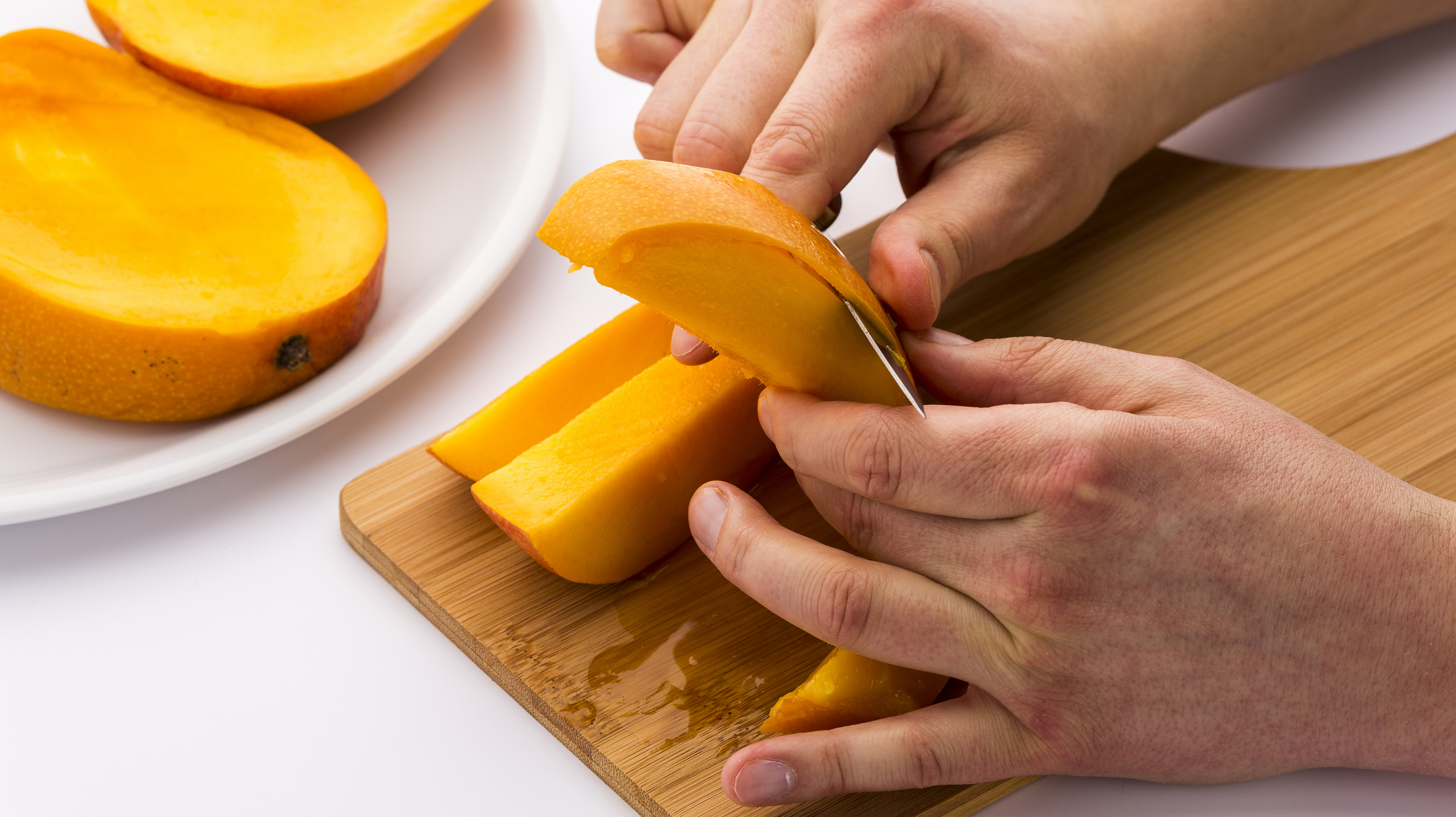 Two Male Hands Peeling A Juicy Mango Fruit Chip