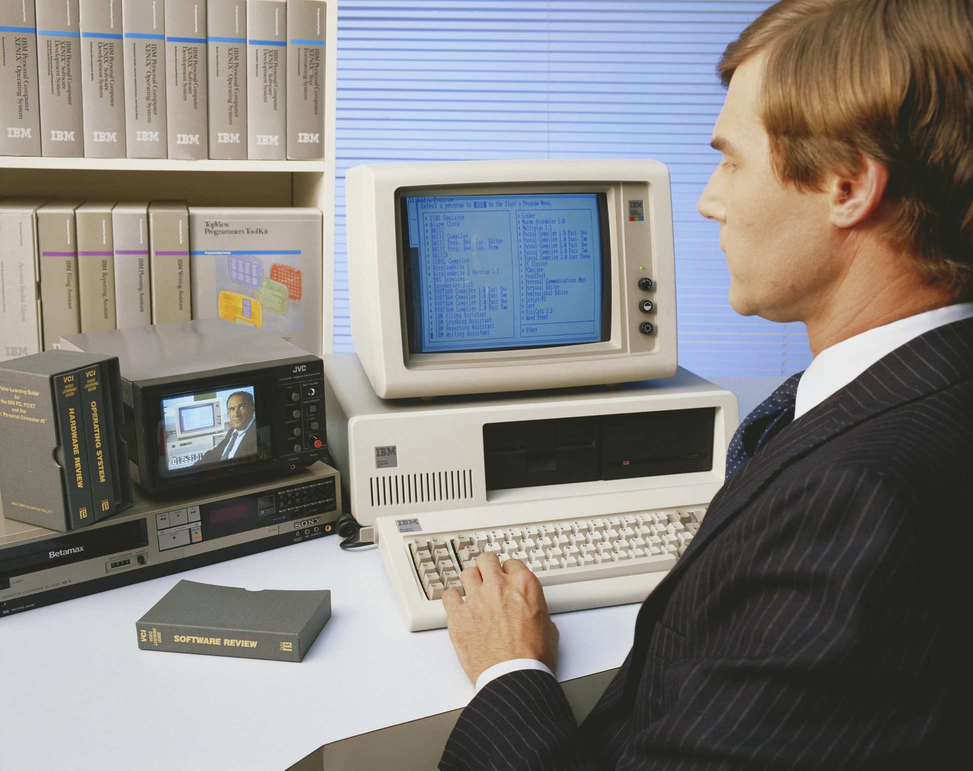 Mid adult man working on old computer and watching video