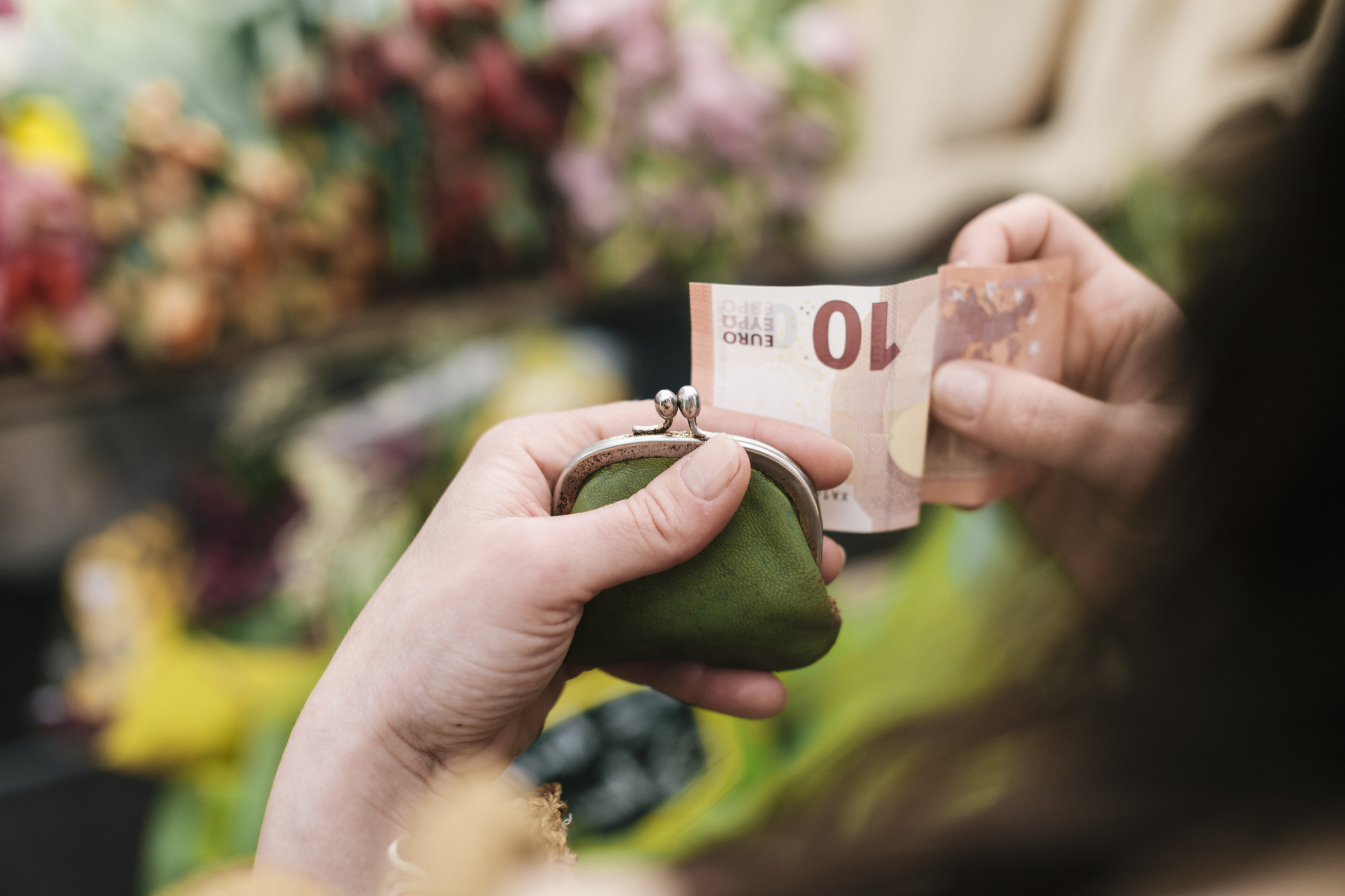 Woman paying for Flowers with 10 Euro Bill