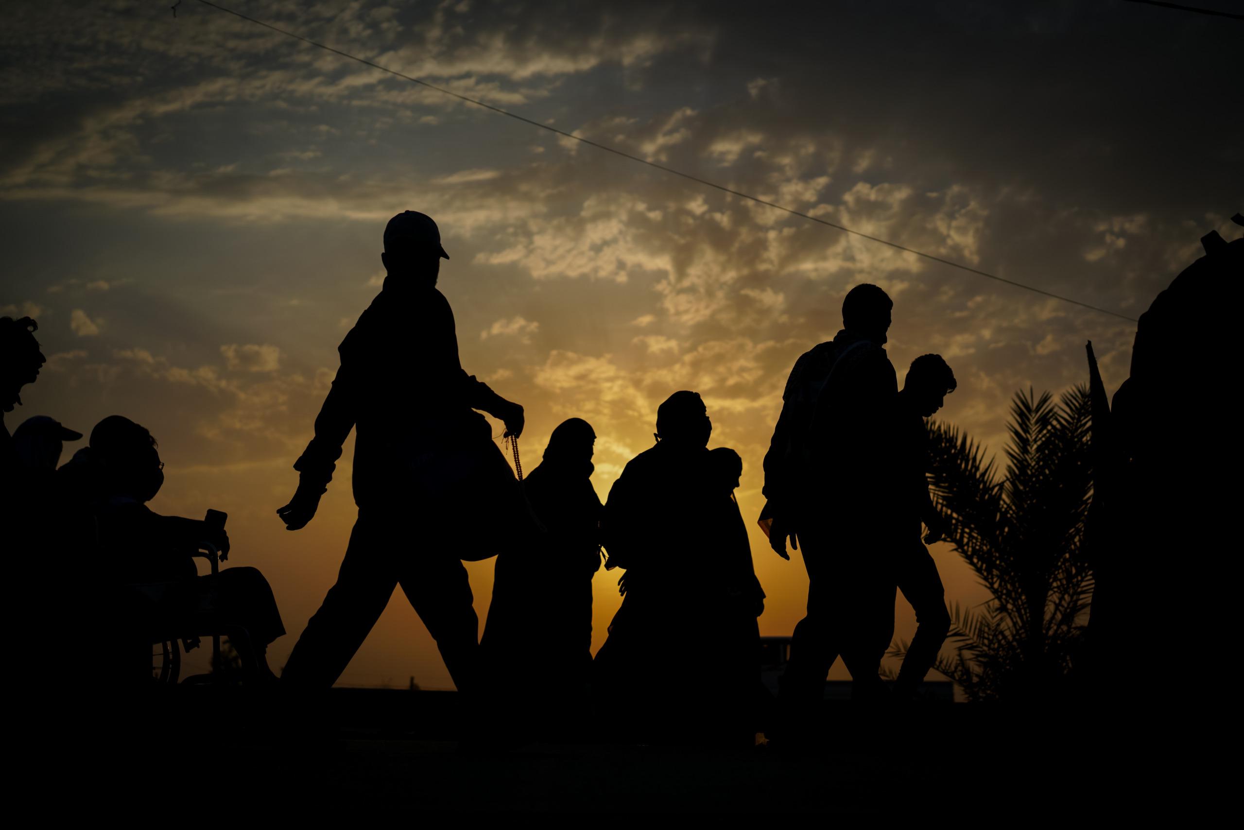 Groups of people walking at sunset