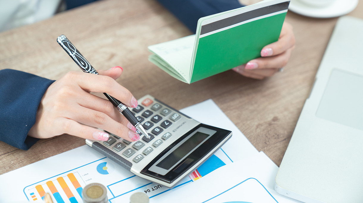 Close up woman doing finance at home office with calculate expenses