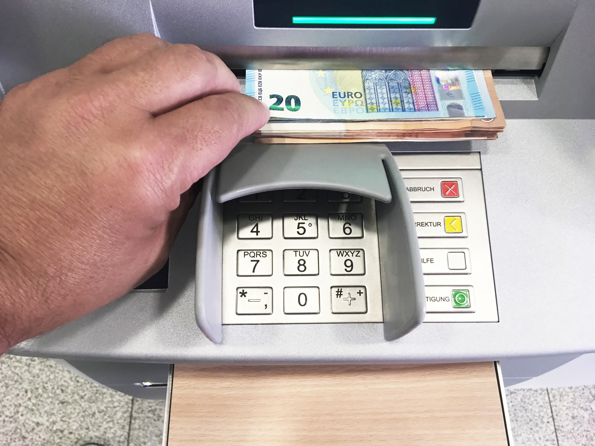 ATM – a hand takes the money