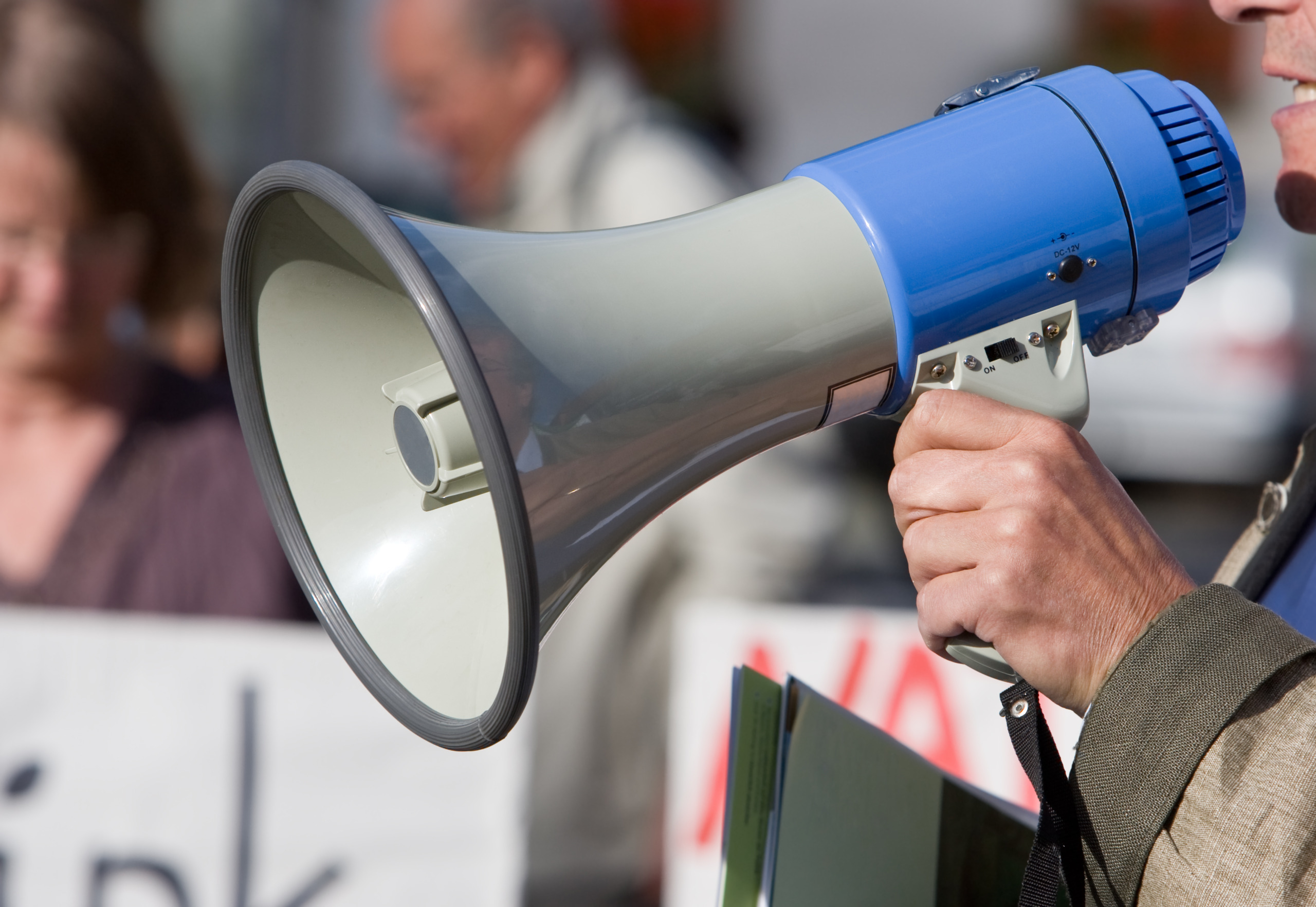 Person talking in a blow horn at a demonstration